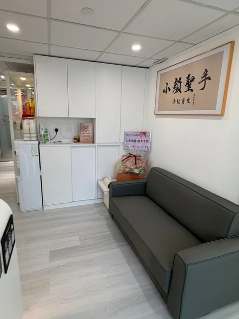 白色收納櫃旁的深色梳化與開業祝賀禮籃